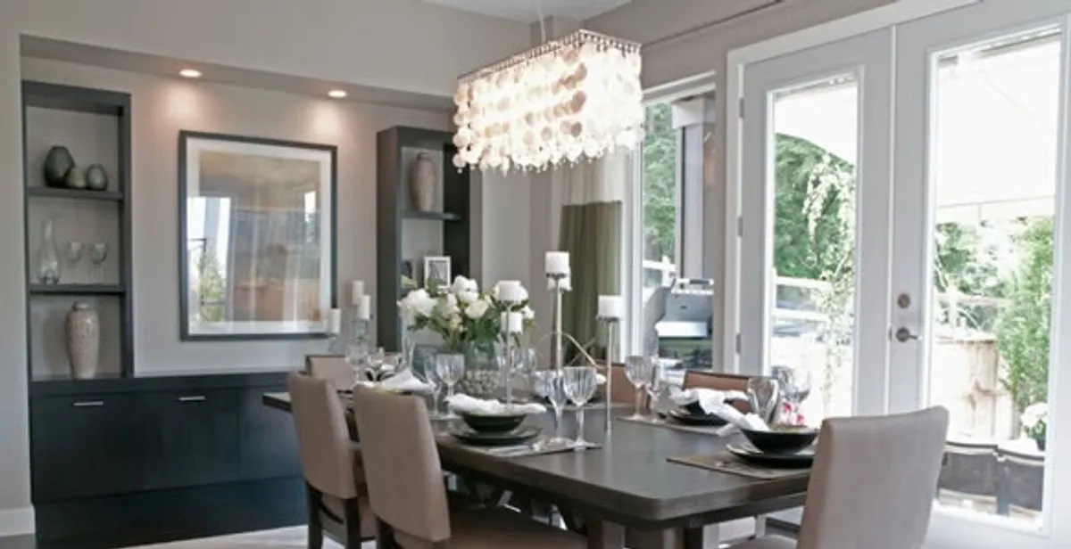 Elegant dining room chandelier installation above table in Baltimore, MD