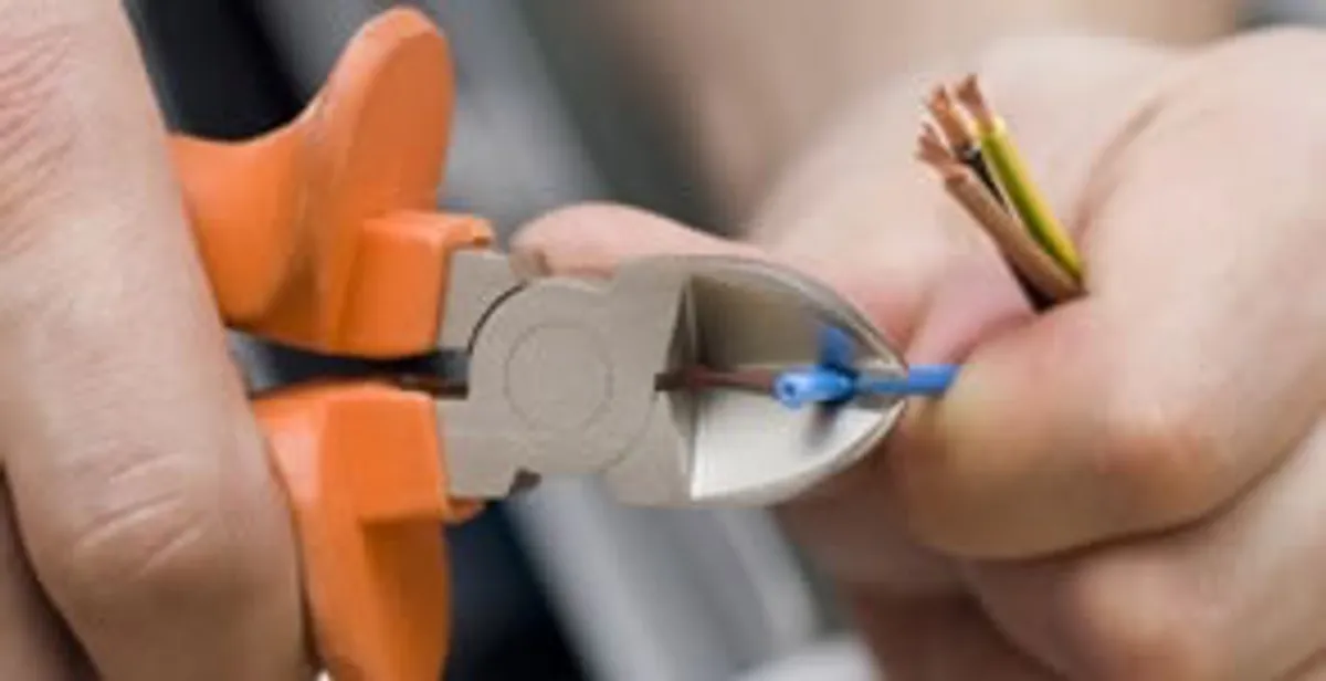professional electrical services showing precise wire cutting by licensed electricians in Baltimore, MD